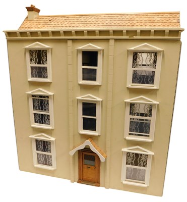 Lot 517 - A 20thC three storey doll's house, painted...
