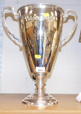 Lot 2079 - A traditional plated sports trophy, twin...