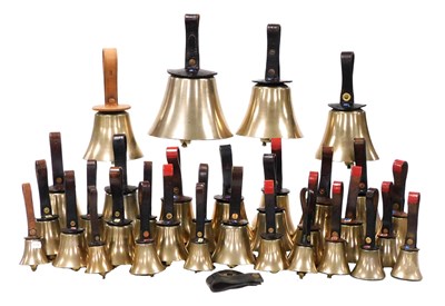 Lot 1 - A collection of brass handbells, with leather...