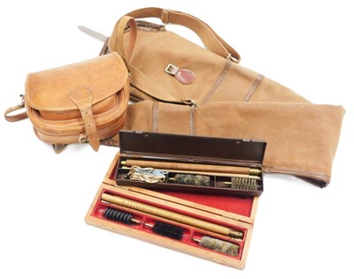 Lot 128 - A canvas gun slip case, a leather cartridge...