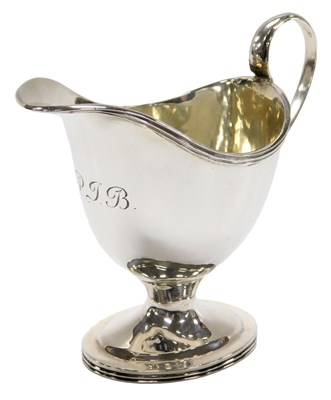 Lot 110 - An Edwardian silver helmet shaped cream jug,...