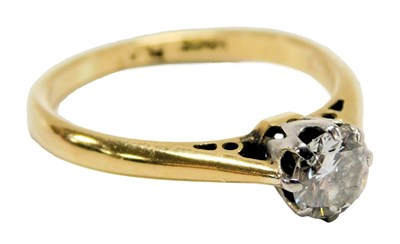 Lot 215 - A diamond solitaire ring, in white and yellow...
