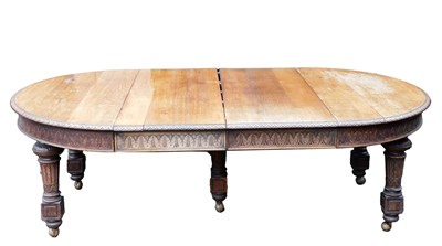 Lot 530 - A Victorian oak wind out dining table, with...