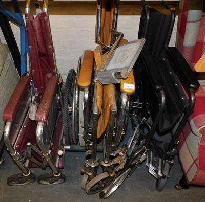 Lot 1015 - A set of three folding wheelchairs, in varying...