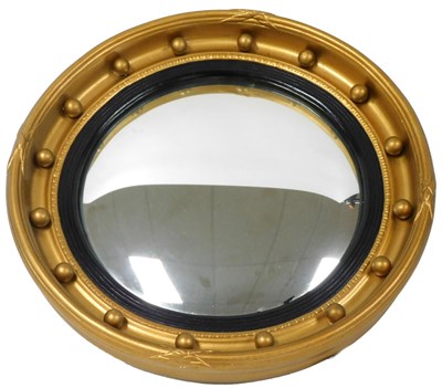 Lot 308 - An early 20thC giltwood convex wall mirror, of...