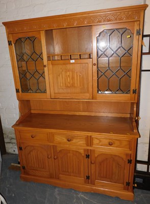 Lot 1023 - A light oak lounge unit, with high level...