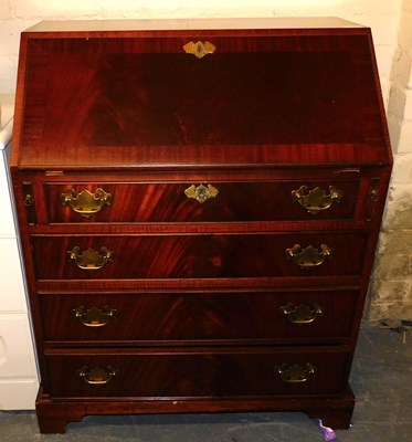 Lot 1027 - A teak four-drawer bureau, with brass...