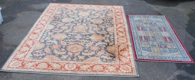 Lot 1030 - Two rugs, a large rug 100% wool, with a gold...
