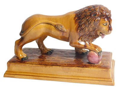 Lot 6 - An early 19thC brown glazed Staffordshire lion,...