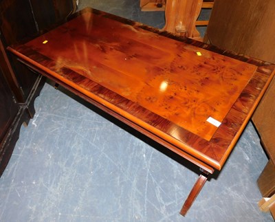 Lot 1053 - A low walnut coffee table, with x shaped legs,...