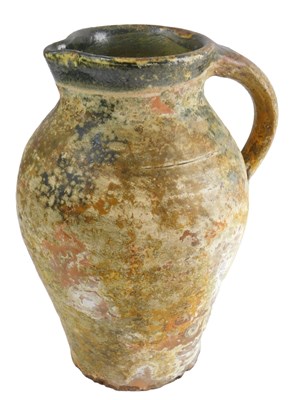 Lot 323 - A glazed terracotta jug, of plain form with a...