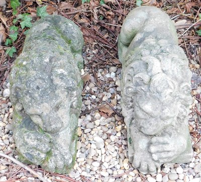 Lot 393 - A pair of recumbent reconstituted stone...