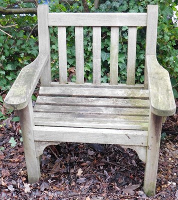 Lot 394 - A slatted teak garden seat, 76cm wide.