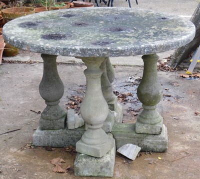 Lot 404 - A reconstituted stone garden table, with a...