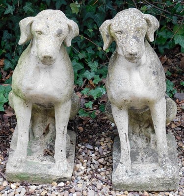 Lot 408 - A pair of reconstituted stone hounds, each on...