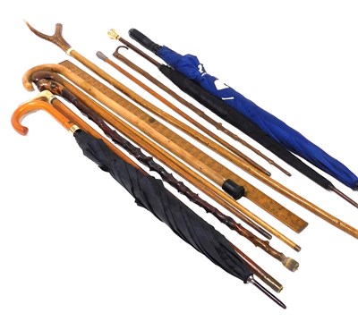 Lot 404 - A group of walking sticks, two with horn...