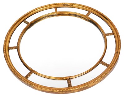 Lot 510 - A Neoclassical style circular gilt wall mirror,...