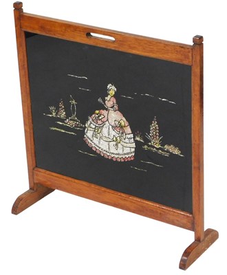 Lot 545 - An early 20thC oak fire screen, set centrally...