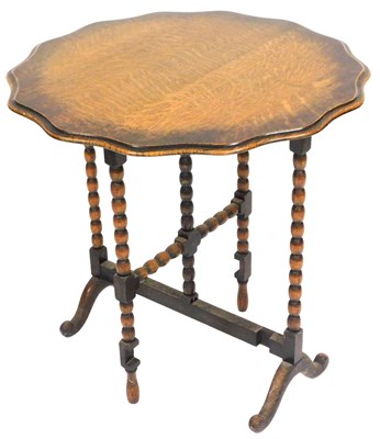 Lot 546 - An early 20thC oak tilt top gate leg...