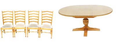 Lot 555 - A Nathan light oak circular draw leaf dining...