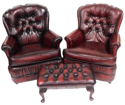 Lot 481 - A pair of oxblood red leather armchairs, with...