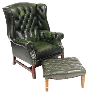 Lot 578 - A green leather wing back armchair, with...