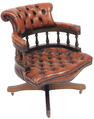 Lot 579 - A oak and tan leather captain's chair, with...