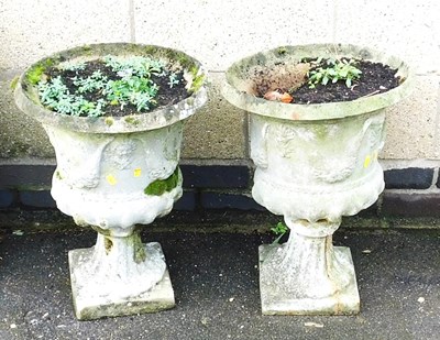 Lot 592 - A pair of reconstituted stone garden urns, of...