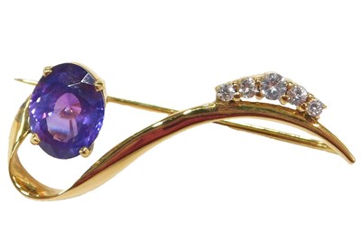 Lot 1084 - A scroll design sapphire brooch, set with a...