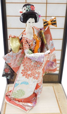 Lot 1243 - A geisha doll, dressed in floral embroidered...
