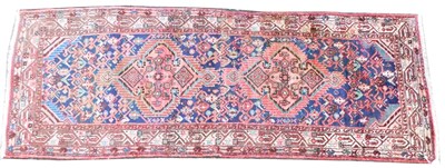 Lot 1404 - A Persian Qashqui red ground rug, decorated...