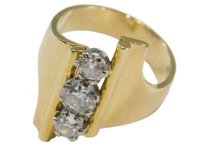 Lot 432 - A diamond three stone ring, in an abstract...