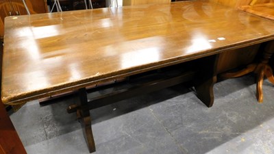 Lot 1519 - An oak trestle dining table.