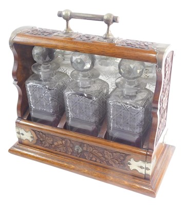 Lot 1114 - An Edwardian carved oak tantalus, with silver...