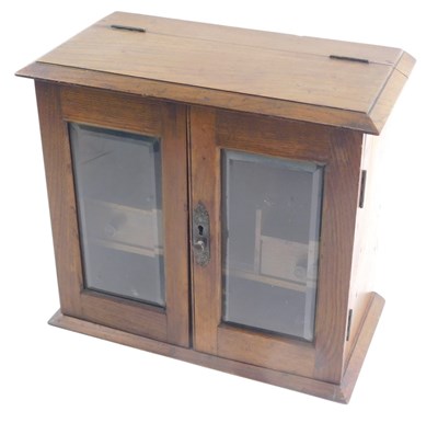 Lot 1115 - An early 20thC oak smoker's cabinet, with...