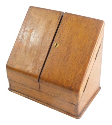 Lot 1116 - An oak writing box, with hinged sloping doors,...