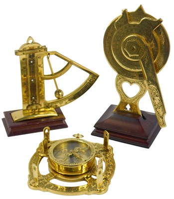 Lot 189 - A Franklin Mint brass nocturnal, on a wooden...