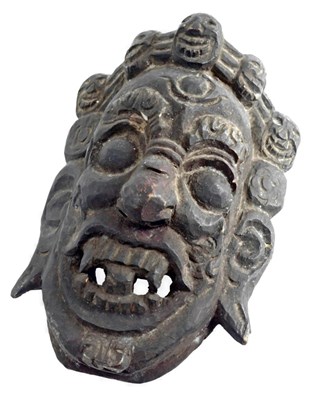 Lot 132 - A carved Nepalese tribal dance mask, label to...