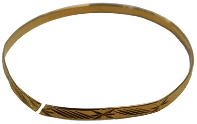 Lot 51 - A bangle with engraved decoration, cut,...