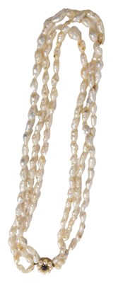 Lot 454 - A three strand natural pearl necklace, with a...