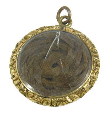 Lot 240 - A Victorian memorial locket, the circular...