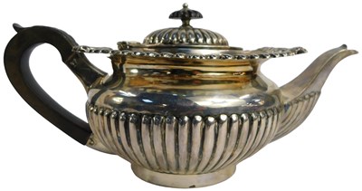Lot 13 - An Edward VII silver teapot, of semi fluted...