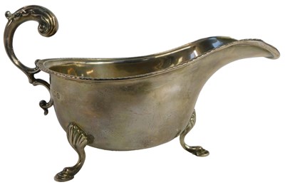 Lot 16 - A George V silver sauce boat, with lappet rim,...