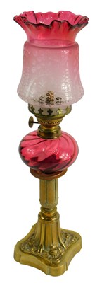 Lot 1496 - A brass and cranberry tinted oil lamp, with...