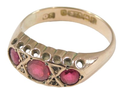 Lot 1010 - A 9ct gold and ruby three stone ring, set with...