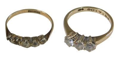 Lot 1033 - A CZ three stone ring, in high claw setting,...