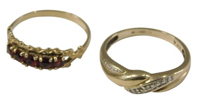 Lot 1034 - A 9ct gold and diamond ring, in a crossover...