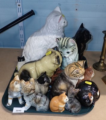 Lot 3049 - A group of ceramic cat figures, to include...