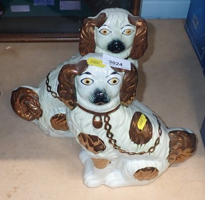 Lot 3024 - A pair of Staffordshire style spaniels, copper...