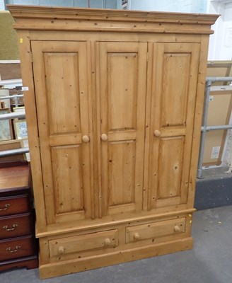 Lot 2501 - A pine triple wardrobe, the top with a moulded...